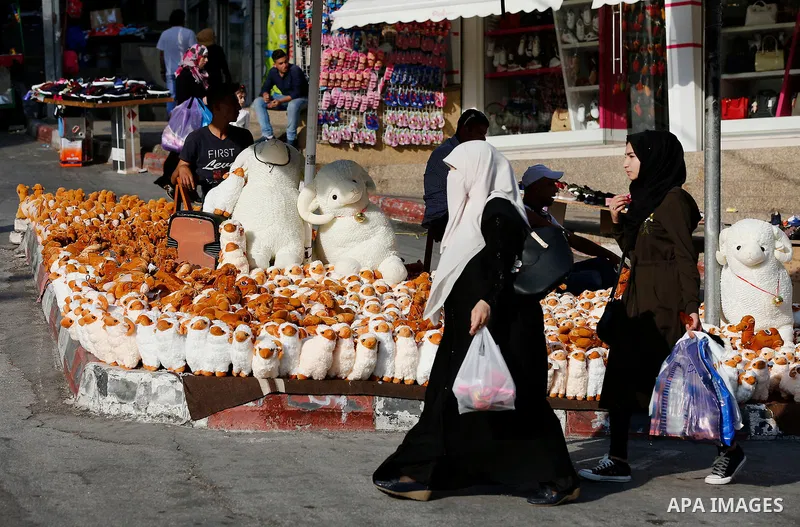 A Palestinian vendor displays toys of sheep at a market ahead of the Eid al-Adha festival in the West Bank city of Hebron, on August 21, 2017. Photo by Wisam Hashlamoun