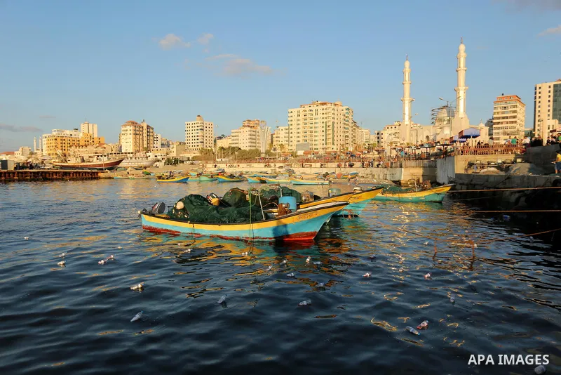 Bottles containing messages against the siege of the Gaza Strip are seen floating in the water at the port in Gaza City after they were thrown into the sea by Palestinian activists on August 22, 2017. The initiative came...
