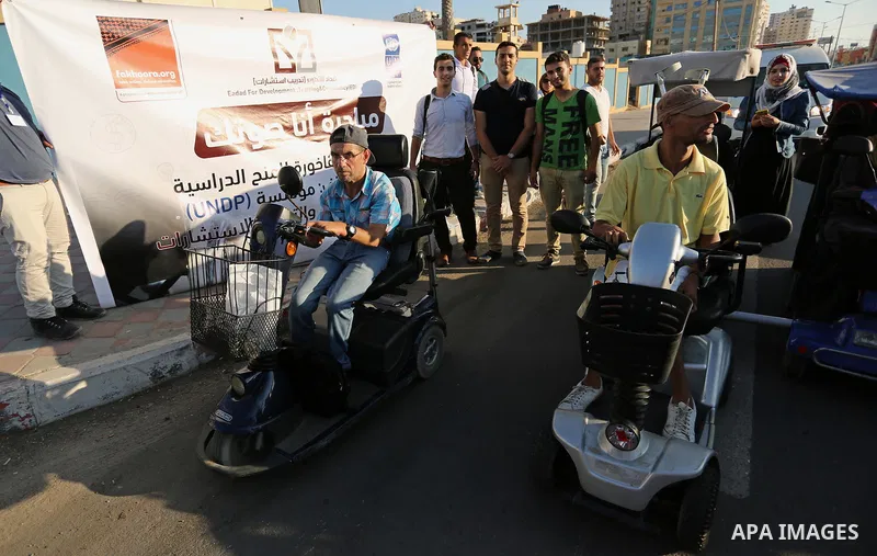 Disabled Palestinians take part in a marathon against the blockade on Gaza strip, in Gaza city on August 22, 2017. Photo by Ashraf Amra