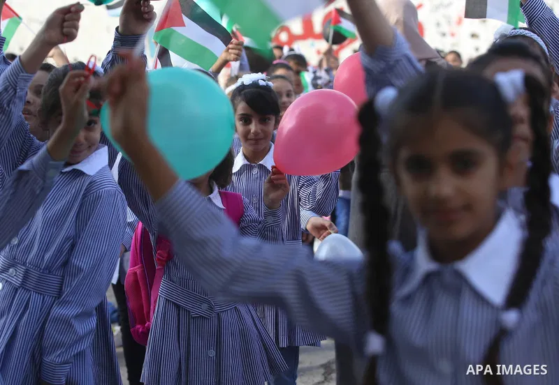Palestinian schoolchildren play on the first day of a new school year, at a school in the West bank city of Nablus August 23, 2017. Photo by Ayman Ameen