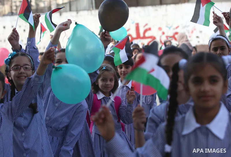 Palestinian schoolchildren play on the first day of a new school year, at a school in the West bank city of Nablus August 23, 2017. Photo by Ayman Ameen