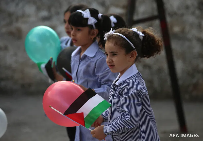 Palestinian schoolchildren play on the first day of a new school year, at a school in the West bank city of Nablus August 23, 2017. Photo by Ayman Ameen