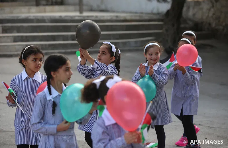 Palestinian schoolchildren play on the first day of a new school year, at a school in the West bank city of Nablus August 23, 2017. Photo by Ayman Ameen