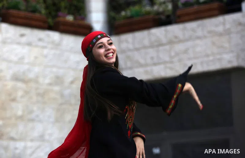 Palestinian Dabka dancers wear a traditional costumes, perform during a festival marking Traditional Palestinian Dress Day, in the West Bank city of Nablus on August 22, 2017. Photo by Ayman Ameen