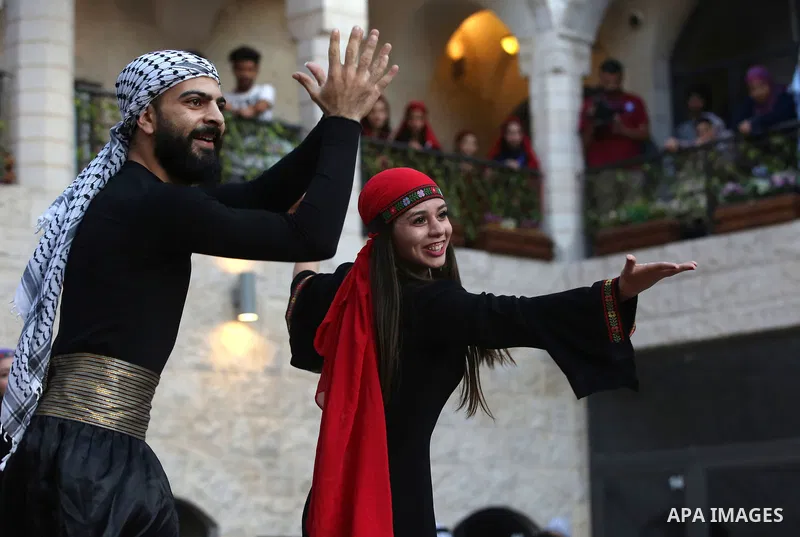 Palestinian Dabka dancers wear a traditional costumes, perform during a festival marking Traditional Palestinian Dress Day, in the West Bank city of Nablus on August 22, 2017. Photo by Ayman Ameen