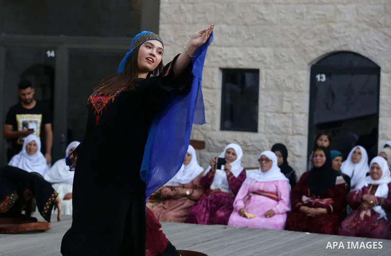 Palestinian Dabka dancers wear a traditional costumes, perform during a festival marking Traditional Palestinian Dress Day, in the West Bank city of Nablus on August 22, 2017. Photo by Ayman Ameen