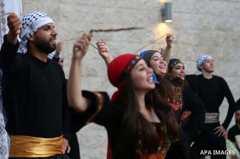 Palestinian Dabka dancers wear a traditional costumes, perform during a festival marking Traditional Palestinian Dress Day, in the West Bank city of Nablus on August 22, 2017. Photo by Ayman Ameen