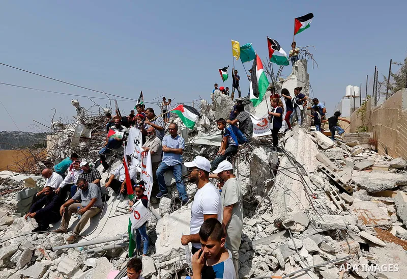 Palestinian protesters take part during demonstration against house demolishing by the Israeli security forces due to the lack of an Israeli-issued construction permit, in the West Bank village of Walajeh, near Bethlehem...