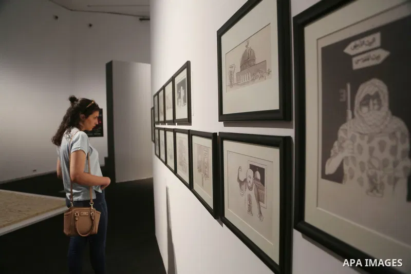 People attend the inaugural exhibition "live Jerusalem", in the West Bank city of Ramallah, on August 26, 2017. Photo by Shadi Hatem