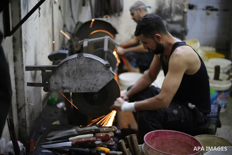 Palestinian ean sharpen knives at their workshop in Gaza city on August 29, 2017. The knives use to slaughter cattle and sheep for the Muslim holiday of Eid al-Adha or the Feast of Sacrifice, which marks the end of the a...