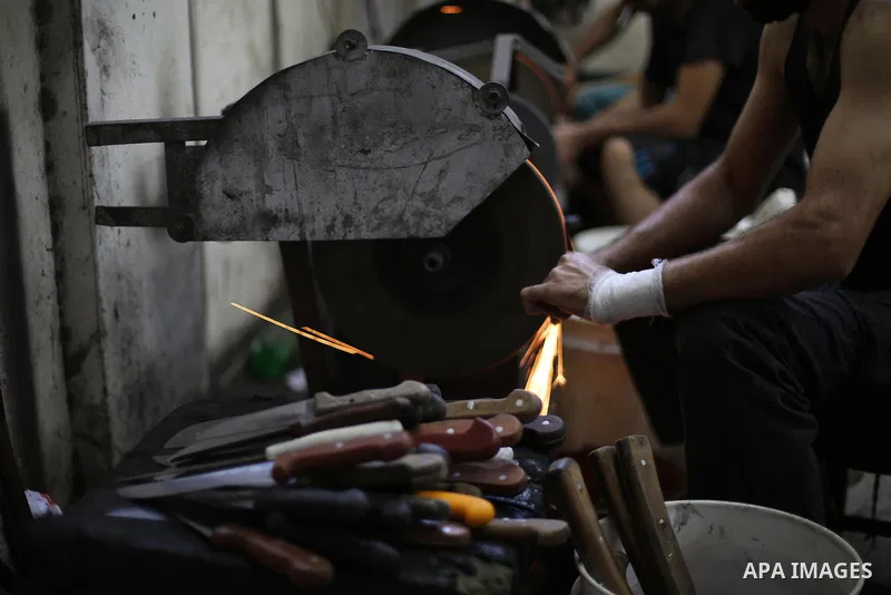 A Palestinian man sharpen knives at his workshop in Gaza city on August 29, 2017. The knives use to slaughter cattle and sheep for the Muslim holiday of Eid al-Adha or the Feast of Sacrifice, which marks the end of the a...