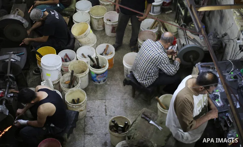A Palestinian man sharpen knives at his workshop in Gaza city on August 29, 2017. The knives use to slaughter cattle and sheep for the Muslim holiday of Eid al-Adha or the Feast of Sacrifice, which marks the end of the a...