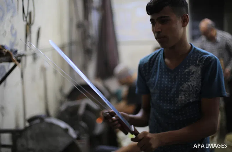 A Palestinian man sharpen knives at his workshop in Gaza city on August 29, 2017. The knives use to slaughter cattle and sheep for the Muslim holiday of Eid al-Adha or the Feast of Sacrifice, which marks the end of the a...