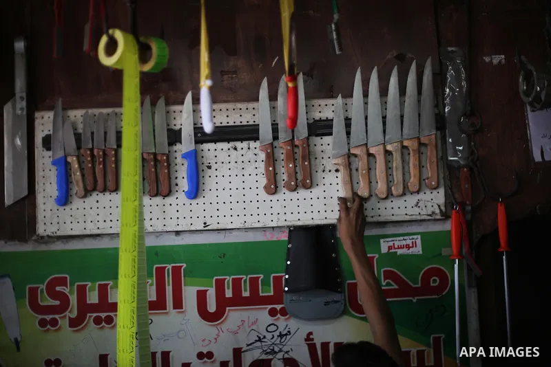 A Palestinian man sharpen knives at his workshop in Gaza city on August 29, 2017. The knives use to slaughter cattle and sheep for the Muslim holiday of Eid al-Adha or the Feast of Sacrifice, which marks the end of the a...