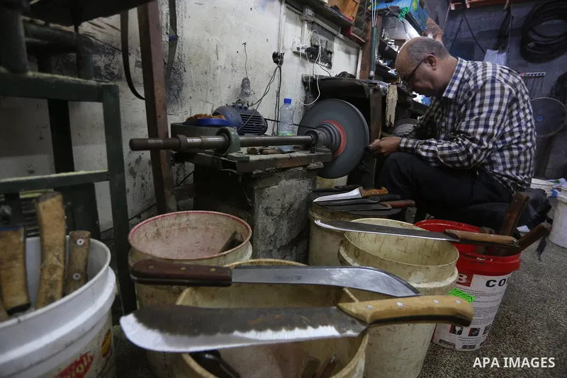 A Palestinian man sharpen knives at his workshop in Gaza city on August 29, 2017. The knives use to slaughter cattle and sheep for the Muslim holiday of Eid al-Adha or the Feast of Sacrifice, which marks the end of the a...