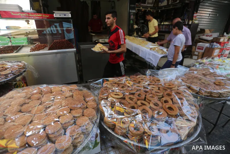 Palestinians shop at a market ahead of Eid al-Adha, in Gaza city on August 31, 2017. Eid al-Adha (the Festival of Sacrifice) is celebrated throughout the Muslim world as a commemoration of Abraham's willingness to sacrif...