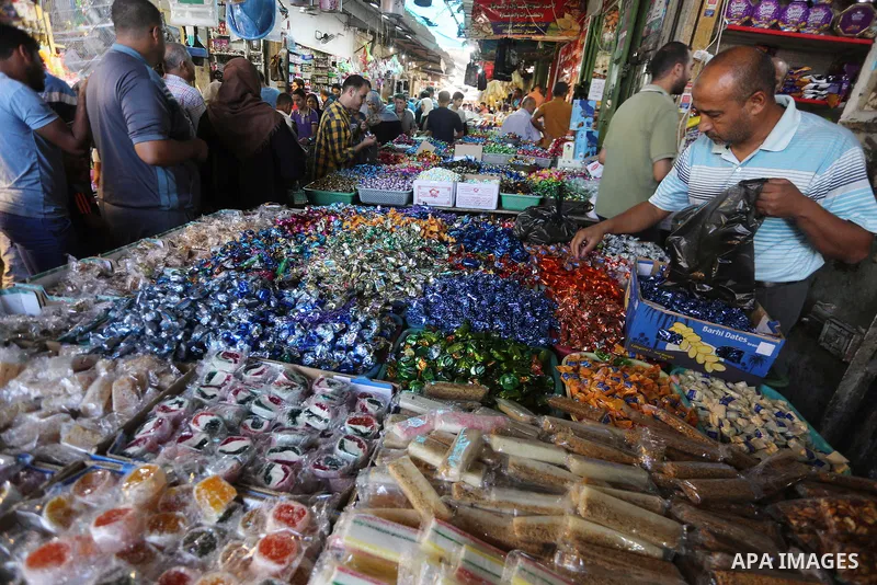Palestinians shop at a market ahead of Eid al-Adha, in Gaza city on August 31, 2017. Eid al-Adha (the Festival of Sacrifice) is celebrated throughout the Muslim world as a commemoration of Abraham's willingness to sacrif...