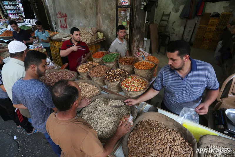 Palestinians shop at a market ahead of Eid al-Adha, in Gaza city on August 31, 2017. Eid al-Adha (the Festival of Sacrifice) is celebrated throughout the Muslim world as a commemoration of Abraham's willingness to sacrif...