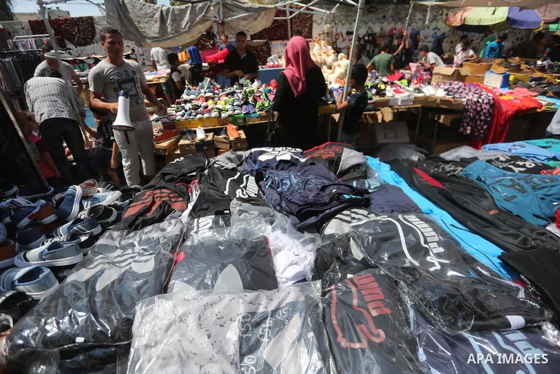 Palestinians shop at a market ahead of Eid al-Adha, in Gaza city on August 31, 2017. Eid al-Adha (the Festival of Sacrifice) is celebrated throughout the Muslim world as a commemoration of Abraham's willingness to sacrif...