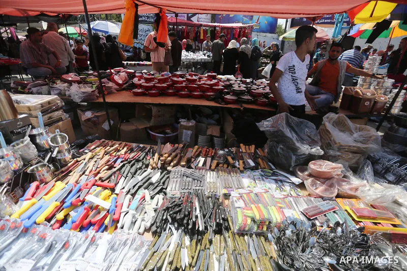 Palestinians shop at a market ahead of Eid al-Adha, in Gaza city on August 31, 2017. Eid al-Adha (the Festival of Sacrifice) is celebrated throughout the Muslim world as a commemoration of Abraham's willingness to sacrif...