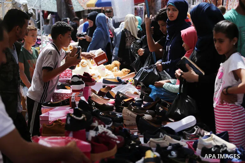 Palestinians shop at a market ahead of Eid al-Adha, in Gaza city on August 31, 2017. Eid al-Adha (the Festival of Sacrifice) is celebrated throughout the Muslim world as a commemoration of Abraham's willingness to sacrif...