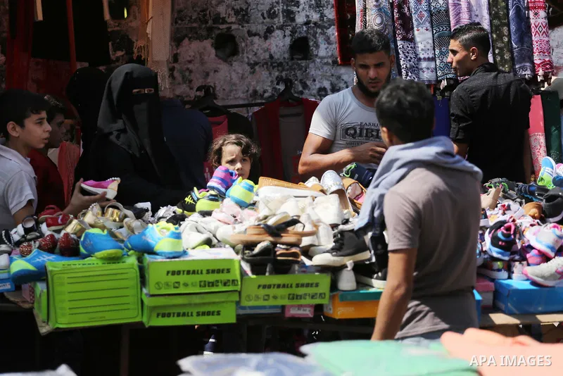 Palestinians shop at a market ahead of Eid al-Adha, in Gaza city on August 31, 2017. Eid al-Adha (the Festival of Sacrifice) is celebrated throughout the Muslim world as a commemoration of Abraham's willingness to sacrif...