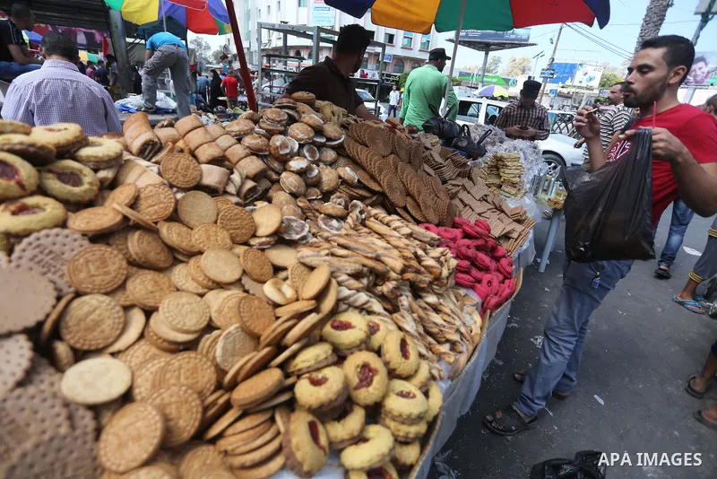 Palestinians shop at a market ahead of Eid al-Adha, in Gaza city on August 31, 2017. Eid al-Adha (the Festival of Sacrifice) is celebrated throughout the Muslim world as a commemoration of Abraham's willingness to sacrif...