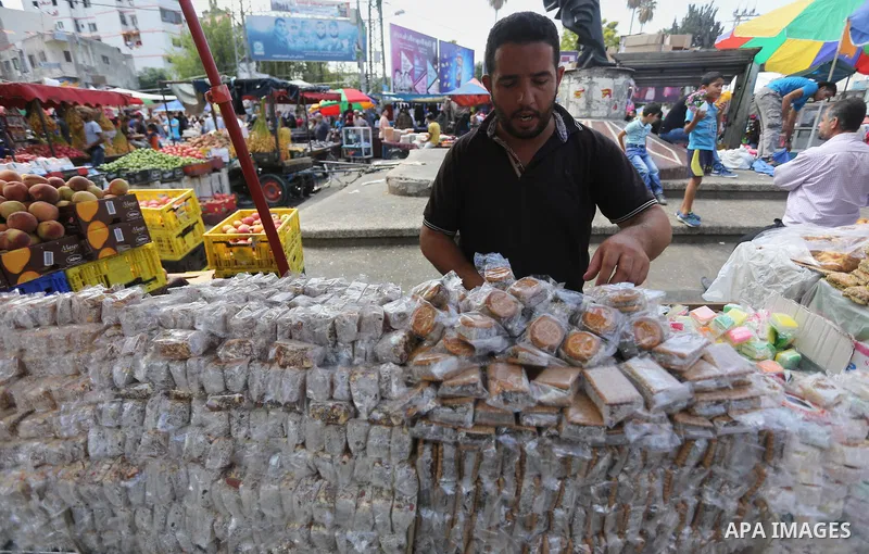 Palestinians shop at a market ahead of Eid al-Adha, in Gaza city on August 31, 2017. Eid al-Adha (the Festival of Sacrifice) is celebrated throughout the Muslim world as a commemoration of Abraham's willingness to sacrif...