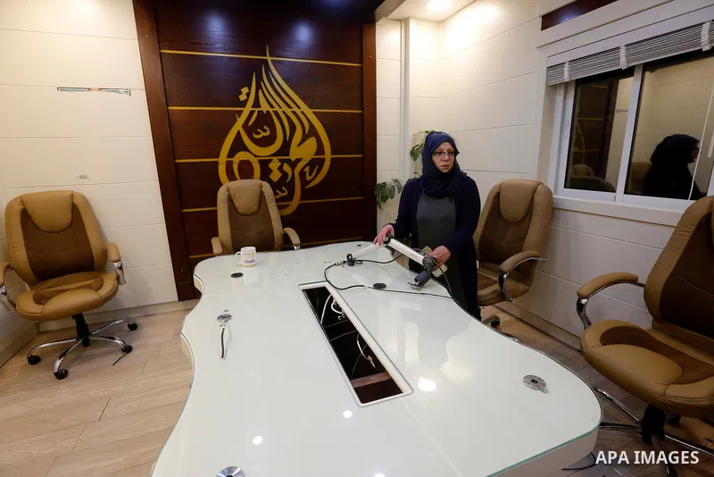 A Palestinian journalist inspects Al Huriya radio station after Israeli troops storm for the closure over charges of incited violence, in West Bank city of Hebron on August 30, 2017. Photo by Wisam Hashlamoun