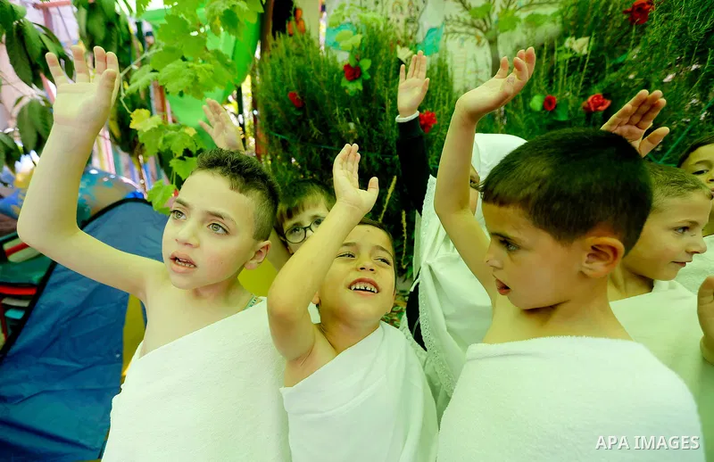 Palestinian children gather around a makeshift cube representing the holy Kaaba, in the West bank city of Hebnron, on August 30, 2017, as part of training children how to perform Hajj pilgrimage. Muslims from around the...