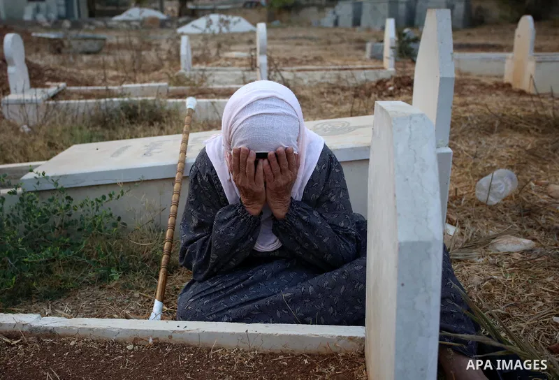 A Palestinian woman visits the grave of her relative at a cemetery on the first day of Eid al-Adha, or feast of the sacrifice, in the West Bank village of Lubban Ash-Sharqiya near Nablus, on September 1, 2017. Muslims ar...