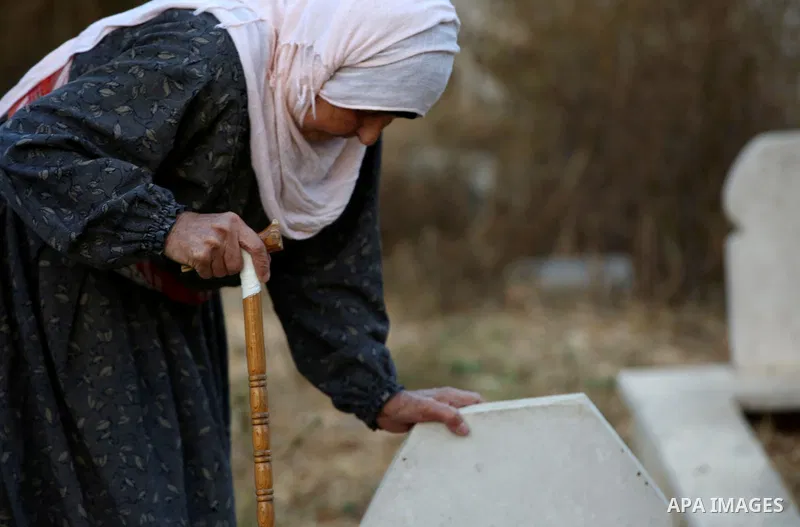 A Palestinian woman visits the grave of her relative at a cemetery on the first day of Eid al-Adha, or feast of the sacrifice, in the West Bank village of Lubban Ash-Sharqiya near Nablus, on September 1, 2017. Muslims ar...
