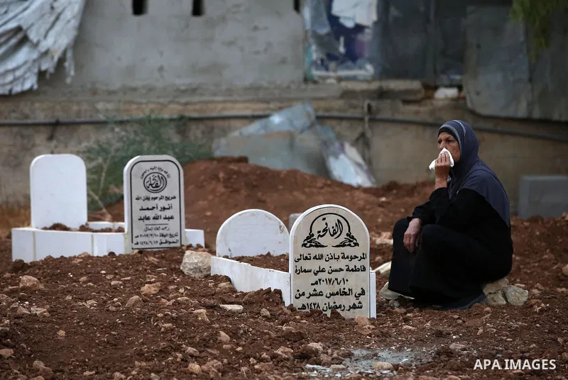 A Palestinian woman visits the grave of her relative at a cemetery on the first day of Eid al-Adha, or feast of the sacrifice, in the West Bank village of Lubban Ash-Sharqiya near Nablus, on September 1, 2017. Muslims ar...