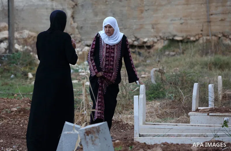 Palestinian women visit graves of their relatives at a cemetery on the first day of Eid al-Adha, or feast of the sacrifice, in the West Bank village of Lubban Ash-Sharqiya near Nablus, on September 1, 2017. Muslims aroun...