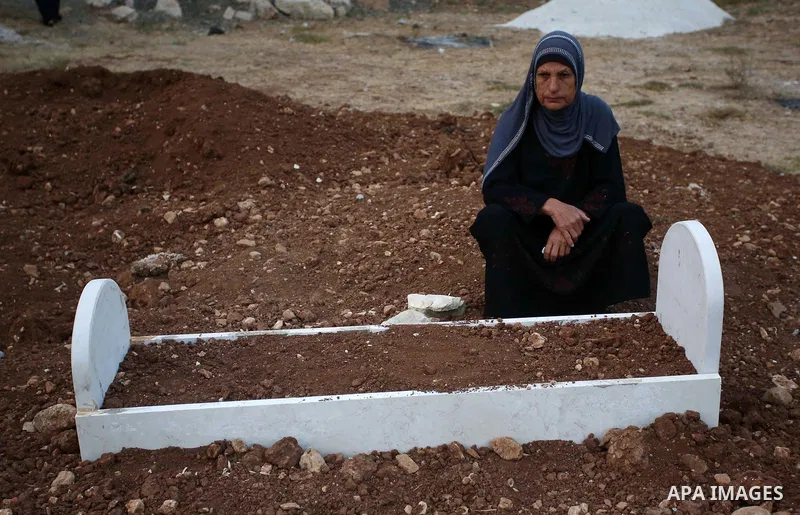 A Palestinian woman visits the grave of her relative at a cemetery on the first day of Eid al-Adha, or feast of the sacrifice, in the West Bank village of Lubban Ash-Sharqiya near Nablus, on September 1, 2017. Muslims ar...