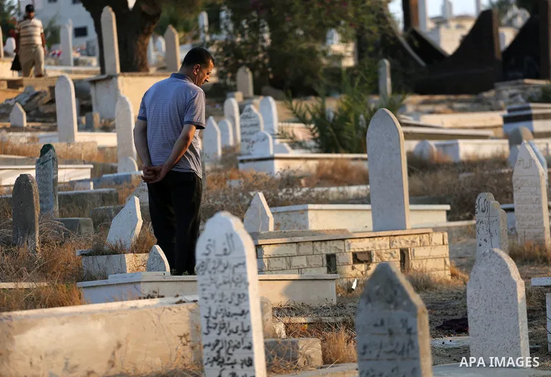 Palestinians visit the grave of their relatives at a cemetery on the first day of Eid al-Adha, or feast of the sacrifice, in Gaza city, on September 1, 2017. Muslims around the world are celebrating Eid al-Adha, the "Fea...