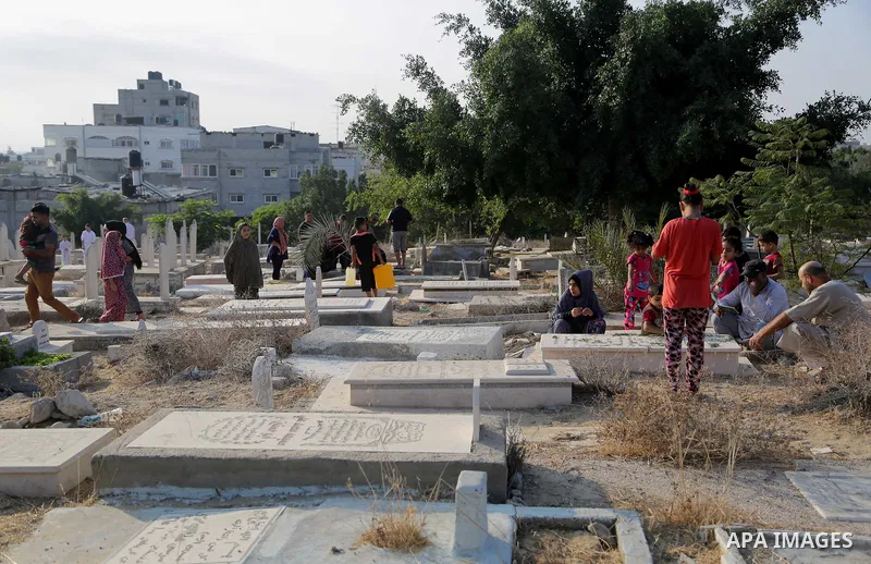 Palestinians visit the grave of their relatives at a cemetery on the first day of Eid al-Adha, or feast of the sacrifice, in Gaza city, on September 1, 2017. Muslims around the world are celebrating Eid al-Adha, the "Fea...