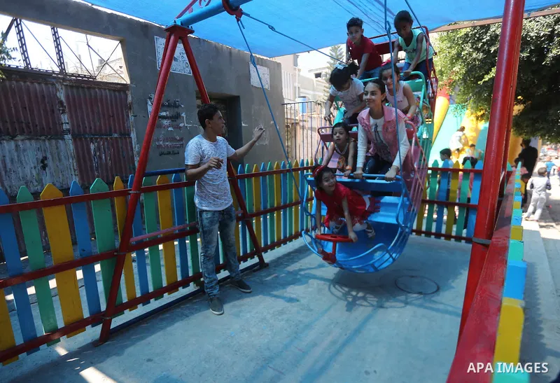 Palestinian children celebrate on of Eid al-Adha or the feast of sacrifice, in Gaza city, on September 1, 2017. Muslims around the world are celebrating Eid al-Adha, the "Feast of Sacrifice", which marks the end of the a...