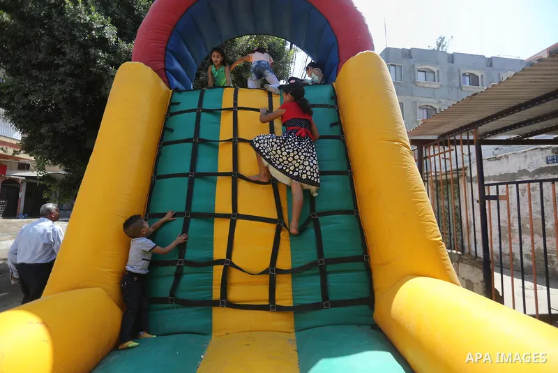 Palestinian children celebrate on of Eid al-Adha or the feast of sacrifice, in Gaza city, on September 1, 2017. Muslims around the world are celebrating Eid al-Adha, the "Feast of Sacrifice", which marks the end of the a...