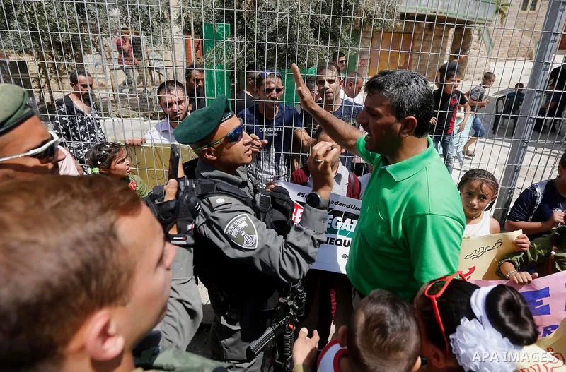 A Palestinian protester argues with Israeli border policemen during a demonstration organised by young Palestinians in Hebron on September 3, 2017, against a recent decision by Israel to boost the powers of the settlers...