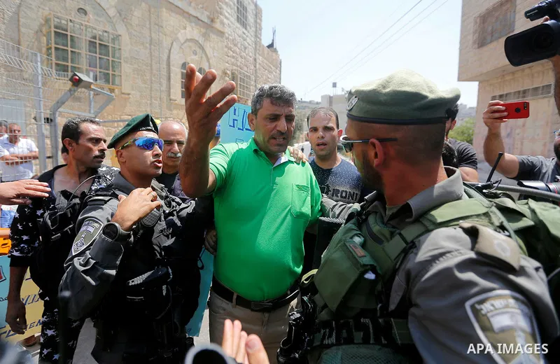 Israeli border police detains a Palestinian man during a demonstration organised by young Palestinians in Hebron on September 3, 2017, against a recent decision by Israel to boost the powers of the settlers in the occupi...