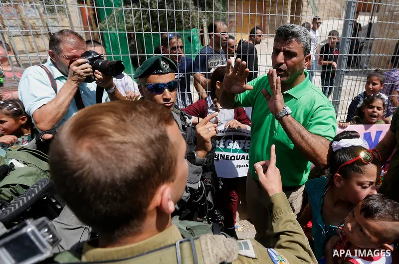 A Palestinian protester argues with Israeli border policemen during a demonstration organised by young Palestinians in Hebron on September 3, 2017, against a recent decision by Israel to boost the powers of the settlers...