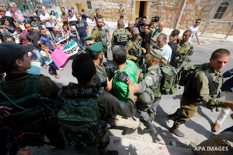 Israeli border police detains a Palestinian man during a demonstration organised by young Palestinians in Hebron on September 3, 2017, against a recent decision by Israel to boost the powers of the settlers in the occupi...