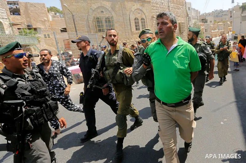 Israeli border police detains a Palestinian man during a demonstration organised by young Palestinians in Hebron on September 3, 2017, against a recent decision by Israel to boost the powers of the settlers in the occupi...