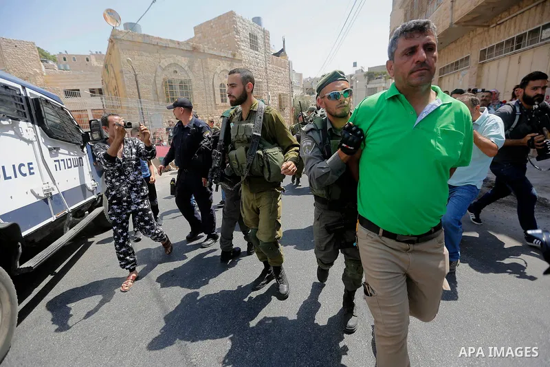 Israeli border police detains a Palestinian man during a demonstration organised by young Palestinians in Hebron on September 3, 2017, against a recent decision by Israel to boost the powers of the settlers in the occupi...