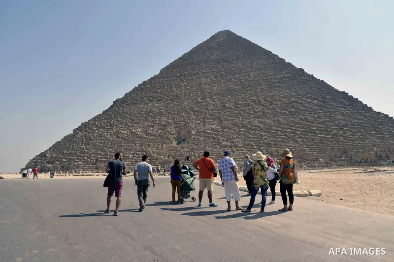 Egyptians celebrate on the third day of Eid al-Adha or the feast of sacrifice, in front of the Giza pyramids, in Cairo on September 03, 2017. Muslims around the world are celebrating Eid al-Adha, the "Feast of Sacrifice"...