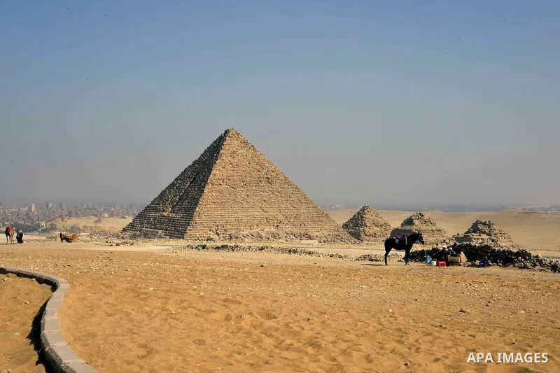 Egyptians celebrate on the third day of Eid al-Adha or the feast of sacrifice, in front of the Giza pyramids, in Cairo on September 03, 2017. Muslims around the world are celebrating Eid al-Adha, the "Feast of Sacrifice"...