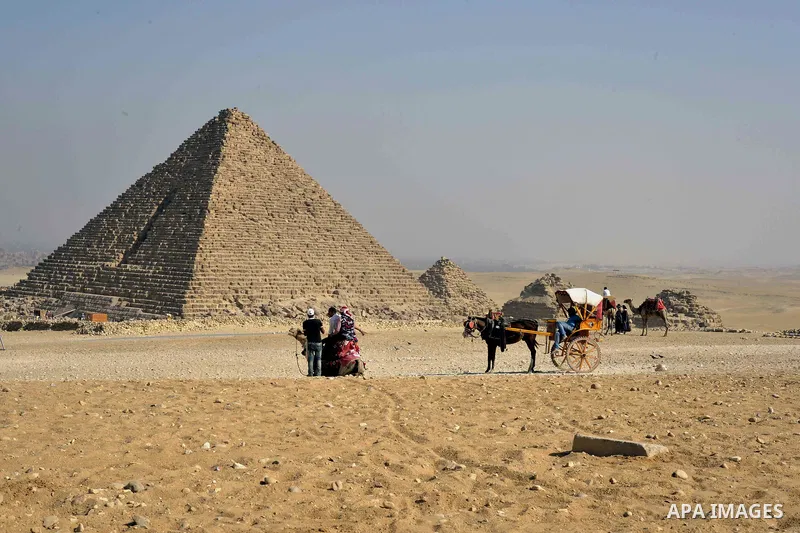 Egyptians celebrate on the third day of Eid al-Adha or the feast of sacrifice, in front of the Giza pyramids, in Cairo on September 03, 2017. Muslims around the world are celebrating Eid al-Adha, the "Feast of Sacrifice"...