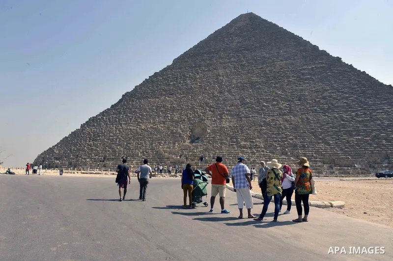 Egyptians celebrate on the third day of Eid al-Adha or the feast of sacrifice, in front of the Giza pyramids, in Cairo on September 03, 2017. Muslims around the world are celebrating Eid al-Adha, the "Feast of Sacrifice"...