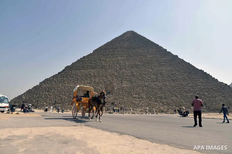 Egyptians ride horse carts on the third day of Eid al-Adha or the feast of sacrifice, in front of the Giza pyramids, in Cairo on September 03, 2017. Muslims around the world are celebrating Eid al-Adha, the "Feast of Sac...
